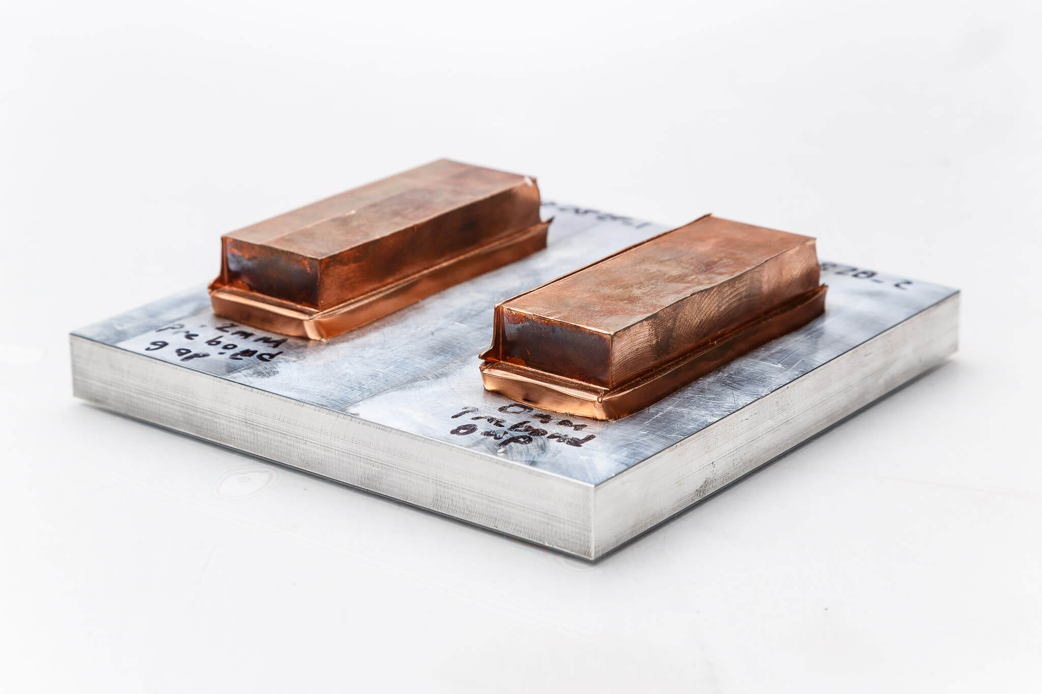Bi-metallic application linear friction welding of copper bars to aluminum plate top angle view